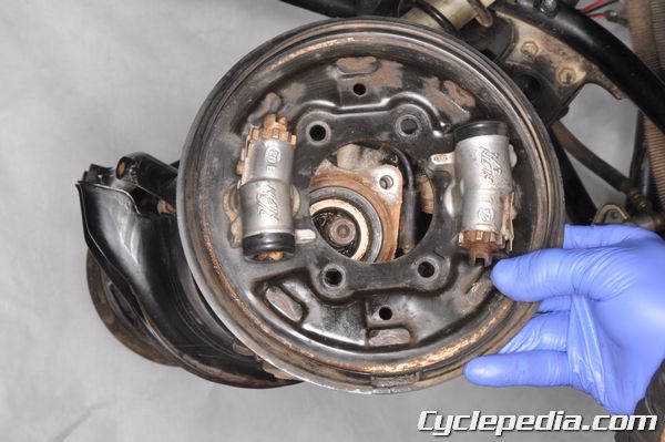 Clean your front drum brake panels on the TRX350D.