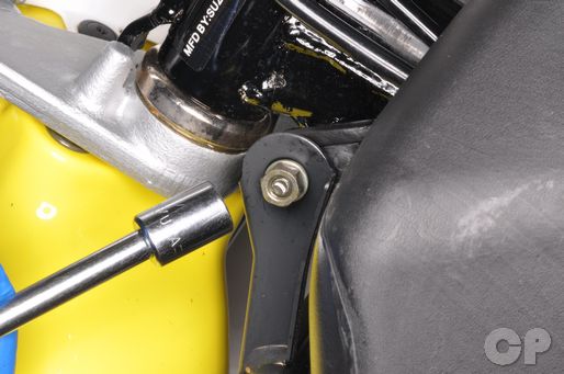 Remove the body work bracket on the Suzuki JR50 or Kawasaki KDX50.