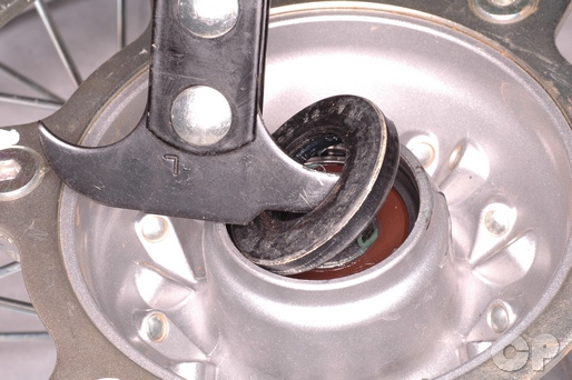 Remove the dust seals to replace the wheel bearings on the CRF150F