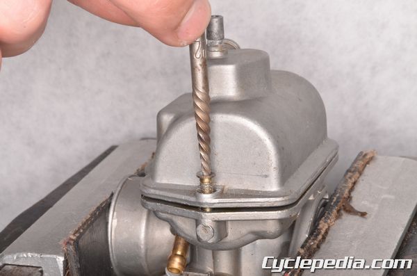 Using a screw extractor to remove a damage screw from a carburetor float bowl