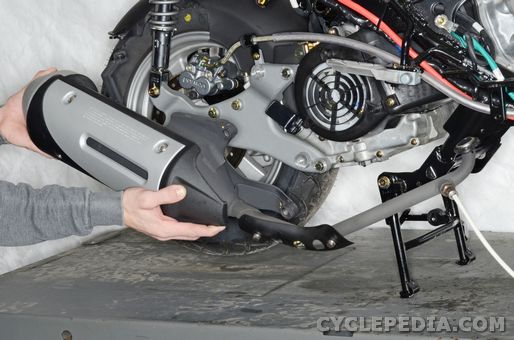 Scooter exhaust systems often must be removed to replace rear tires